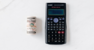 A calculator and cash used to pay closing costs as a buyer.