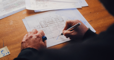 Appraiser looking at house plan specifications