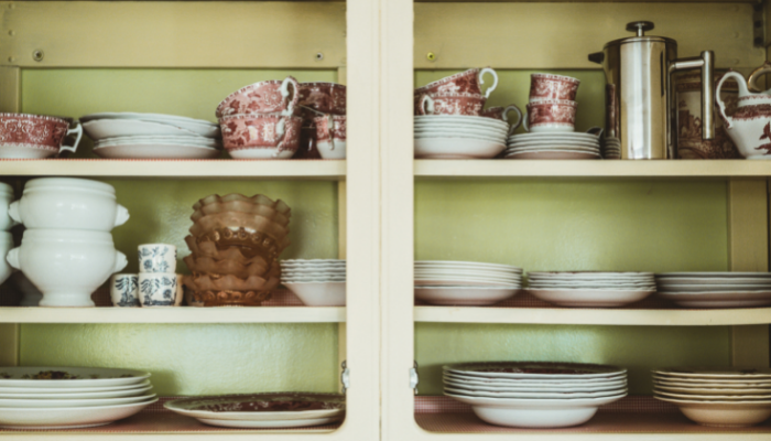 A cabinet full of plates in a house for sale.